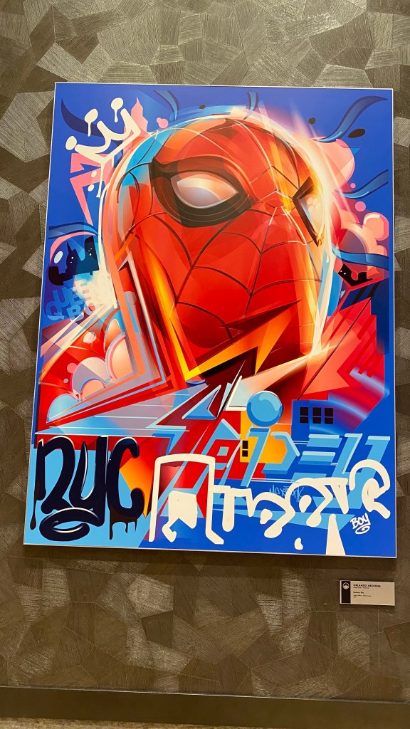 A picture of Artwork depicting a close up of Spider-man's face with grafitti style scribbles and tags on and around it 